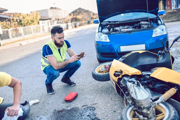 Lawyer Standing Beside a Crashed Motorcycle