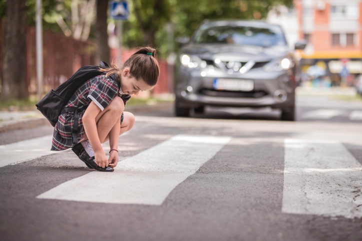 Girl Fixing Shoes, Unaware of Nearby Pedestrian Accident in Las Vegas, NV