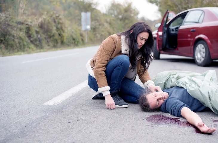 Woman Helping an Injured Pedestrian After an Accident