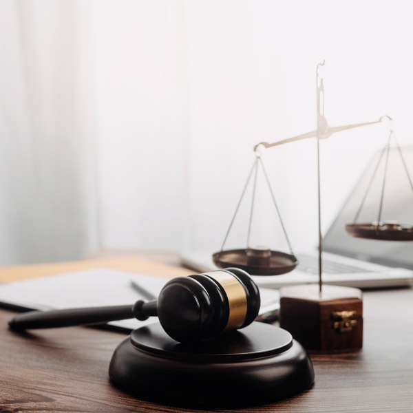 Close-up view of a judge’s gavel and scales of justice on a wooden desk in Las Vegas, NV