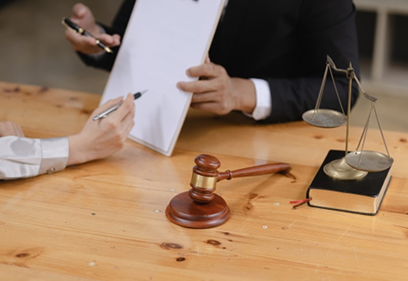 Lawyer presenting documents for reviewing settlement offer in Las Vegas, NV