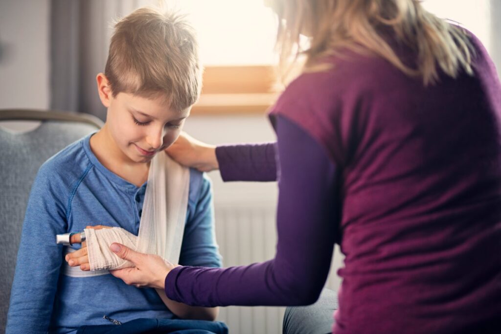 child care assistant taking care of injury