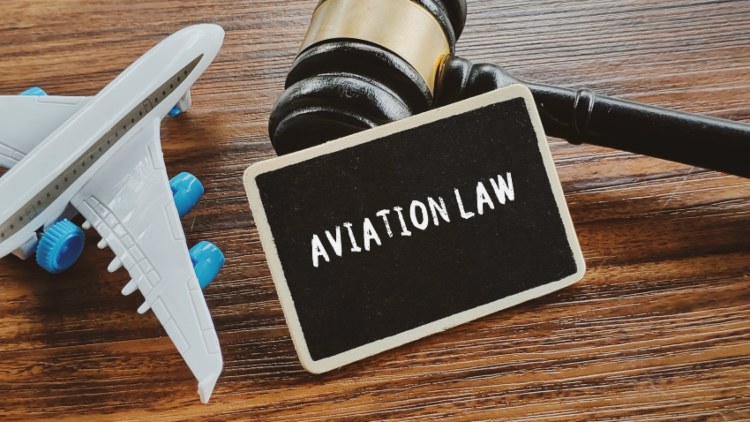 Aviation law concept explained with a gavel and airplane model for legal claims